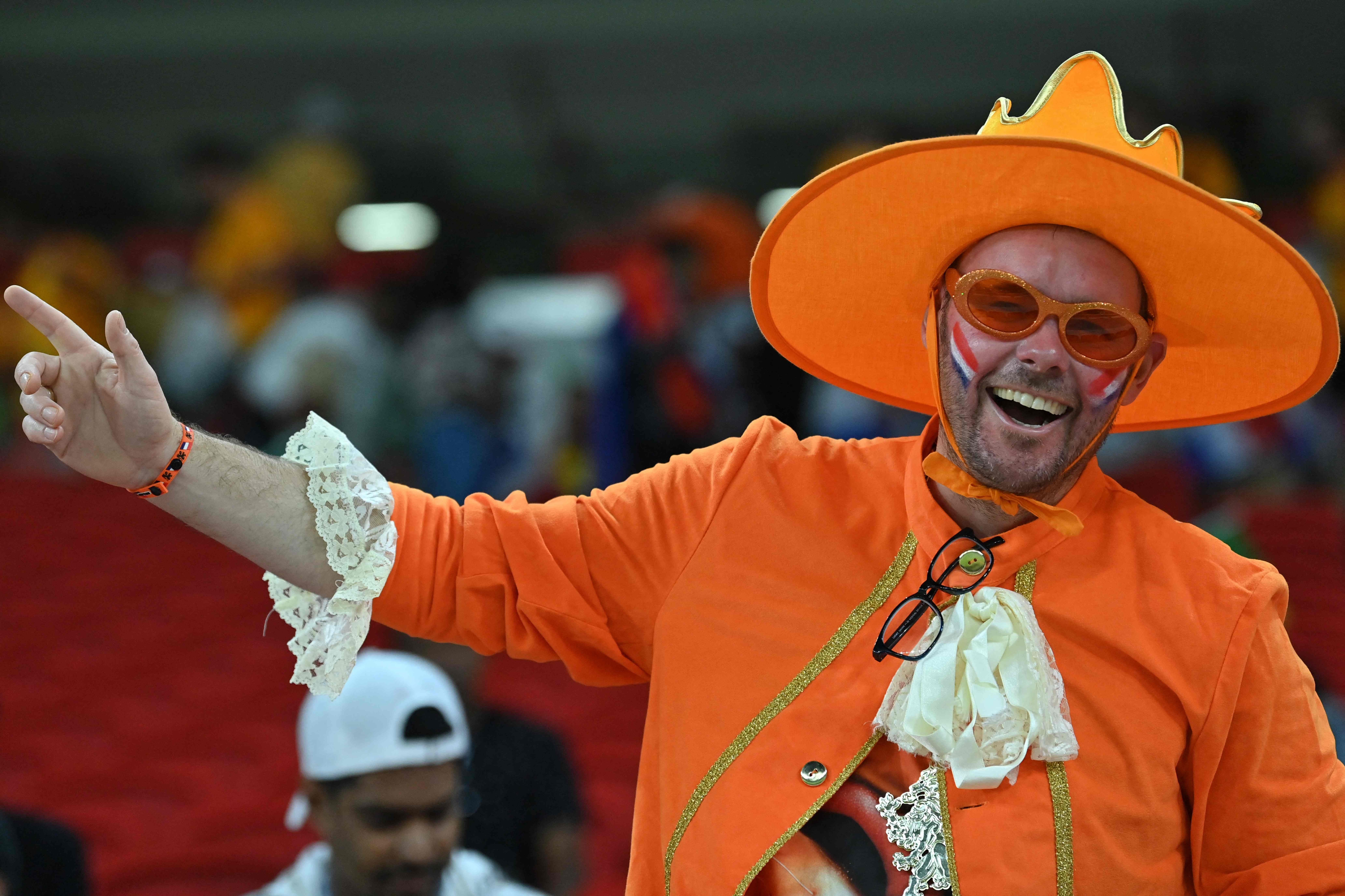 A Netherlands' supporter takes their seat for the Qatar 2022 World Cup Group A football match between Senegal and the Netherlands at the Al-Thumama Stadium in Doha on November 21, 2022. (Photo by Glyn KIRK / AFP)