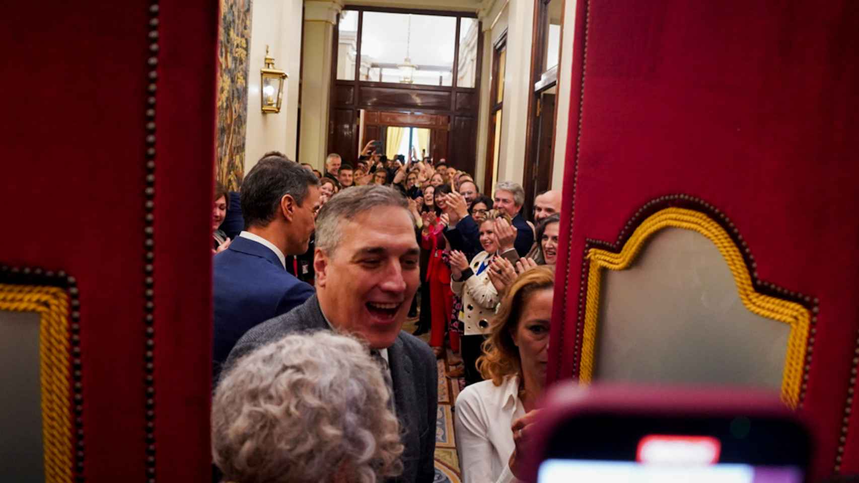 Diputados y trabajadores del PSOE hacen el pasillo a Pedro Sánchez, recién investido presidente del Gobierno, en el Congreso.